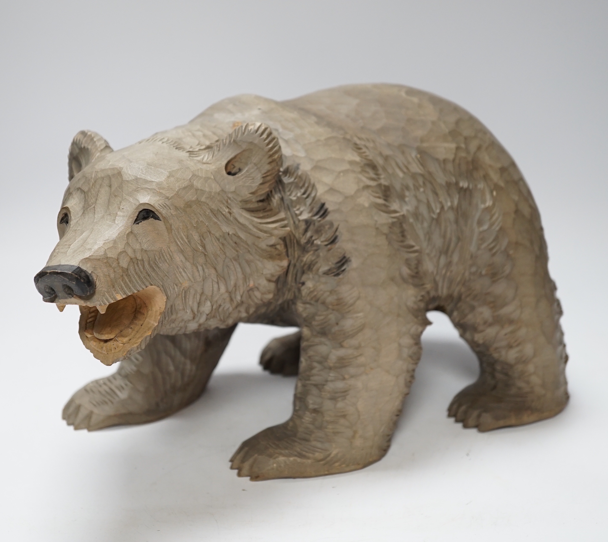 A Japanese carved wood bear, 32cm long